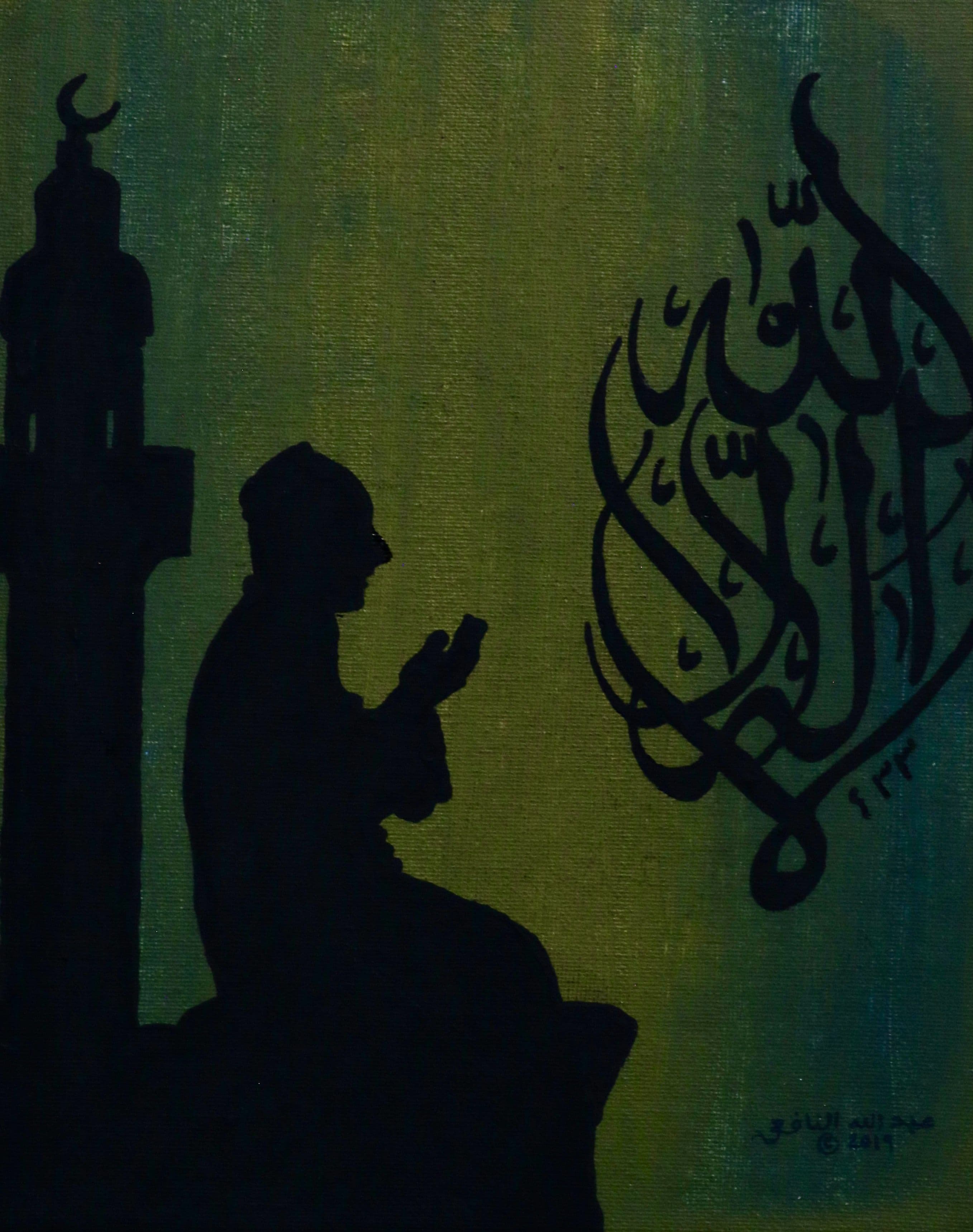 imam praying beneath a minaret